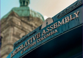 Report cover image showing a sign that says "Legislative Assembly of British Columbia" with the distinctive stone walls and copper roof of the legislative buildings in the background